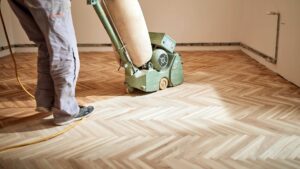 Our team buffing hardwood floors with a "V" pattern